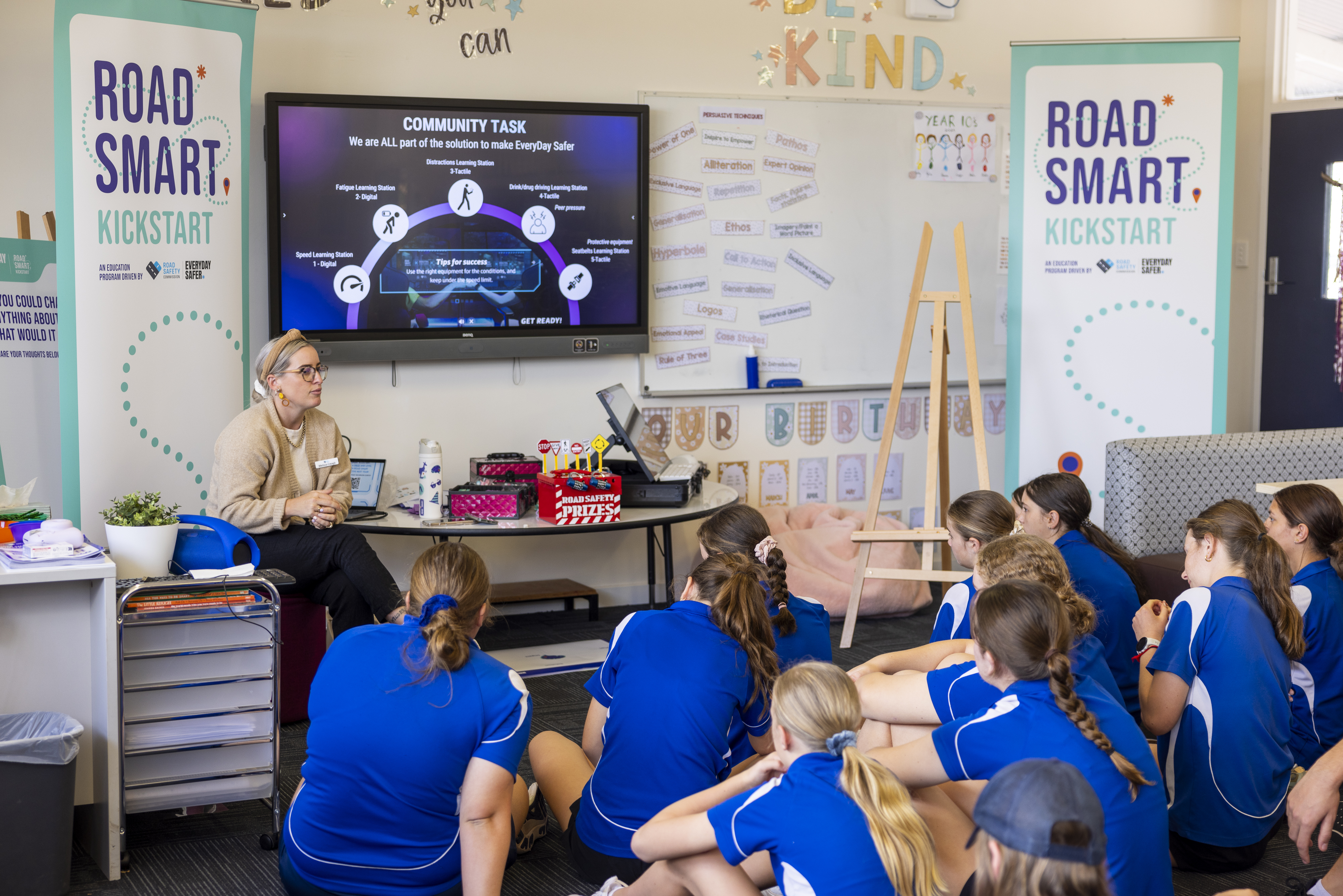 Facilitator talking in front of the class about the community task. 
